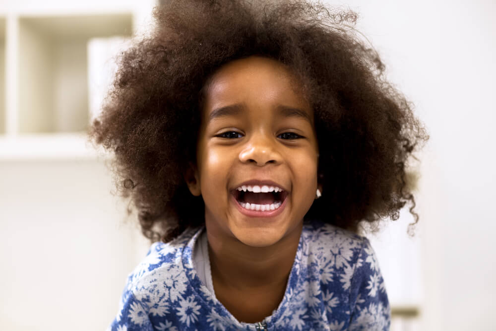 Smiling little girl with healthy white teeth